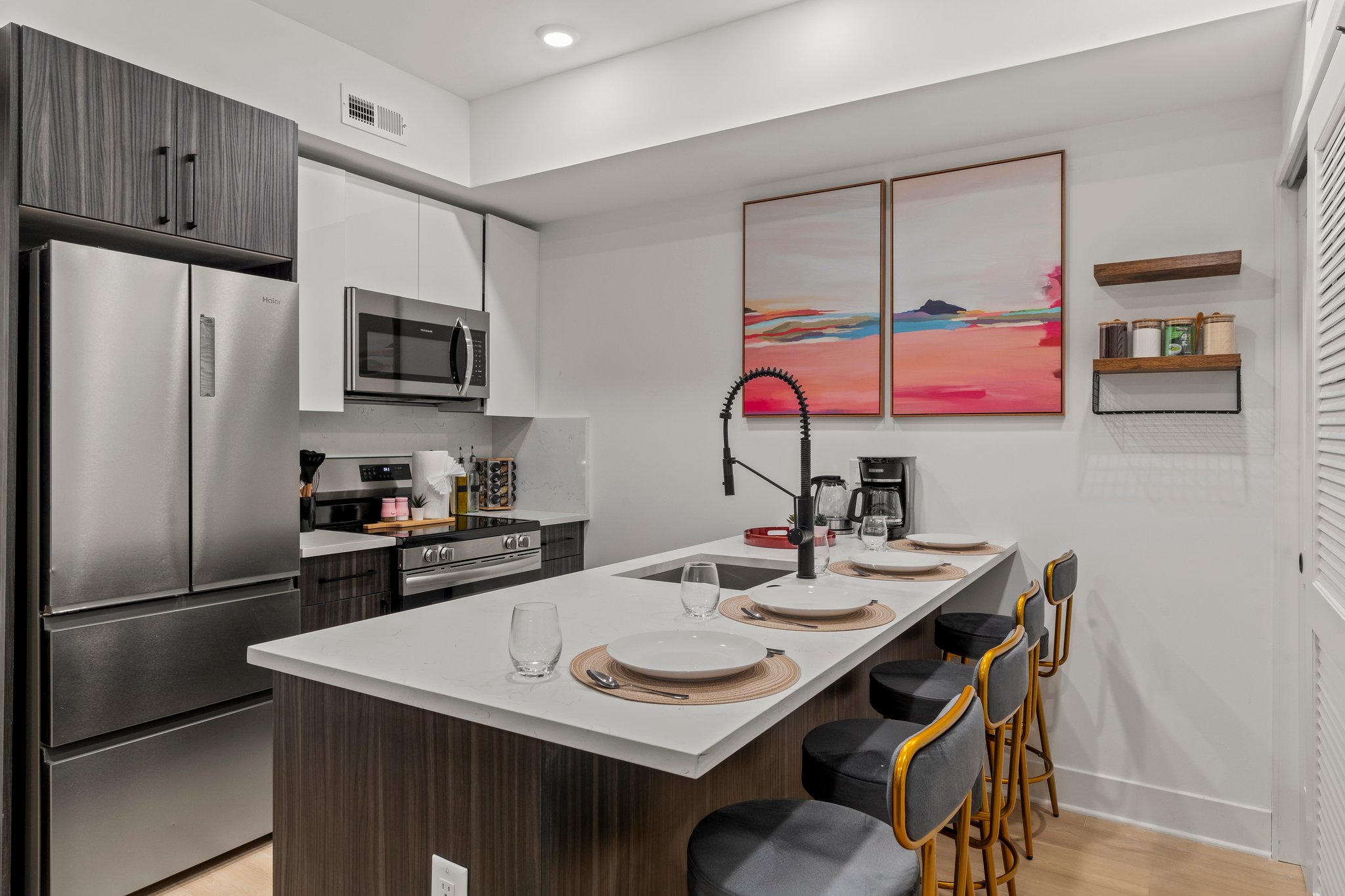 Kitchen with stainless appliances and island bar seating