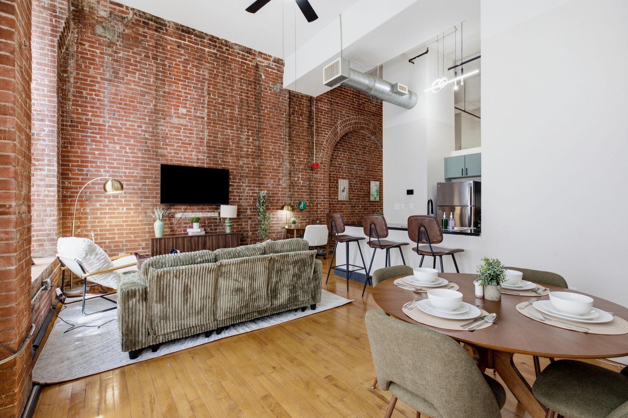 Dining nook beneath oversized arched windows