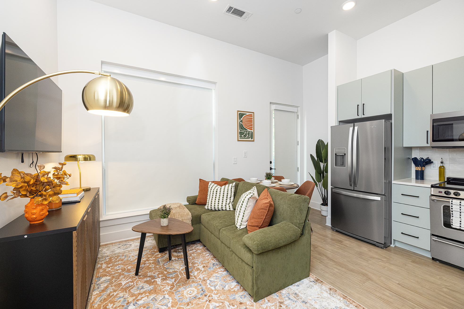Open-concept kitchen and living space with brick archway